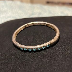Kids silver bracelet with 7 blue rhinestones each side of bracelet. Gently used